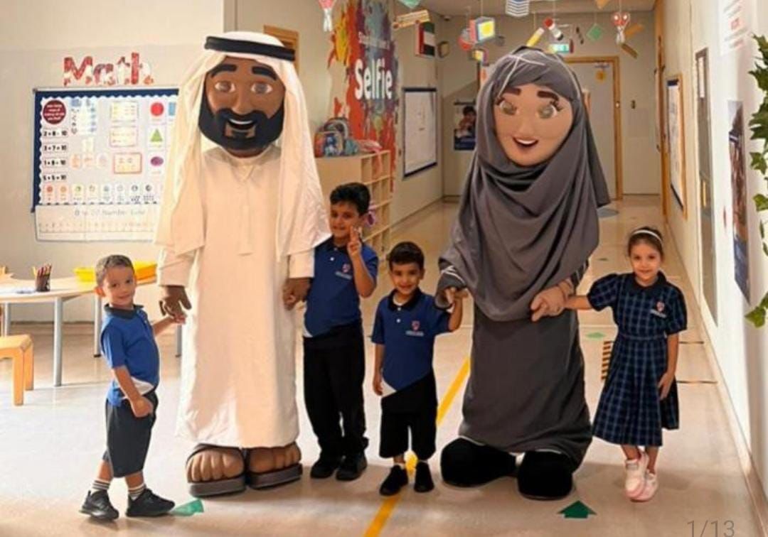 School children with large mascot characters at an event